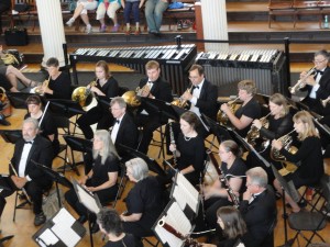 The horn section of the Casco Bay Wind Symphony plays in historic Faneuil Hall.